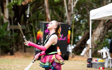 A circus performer, juggling three knives.